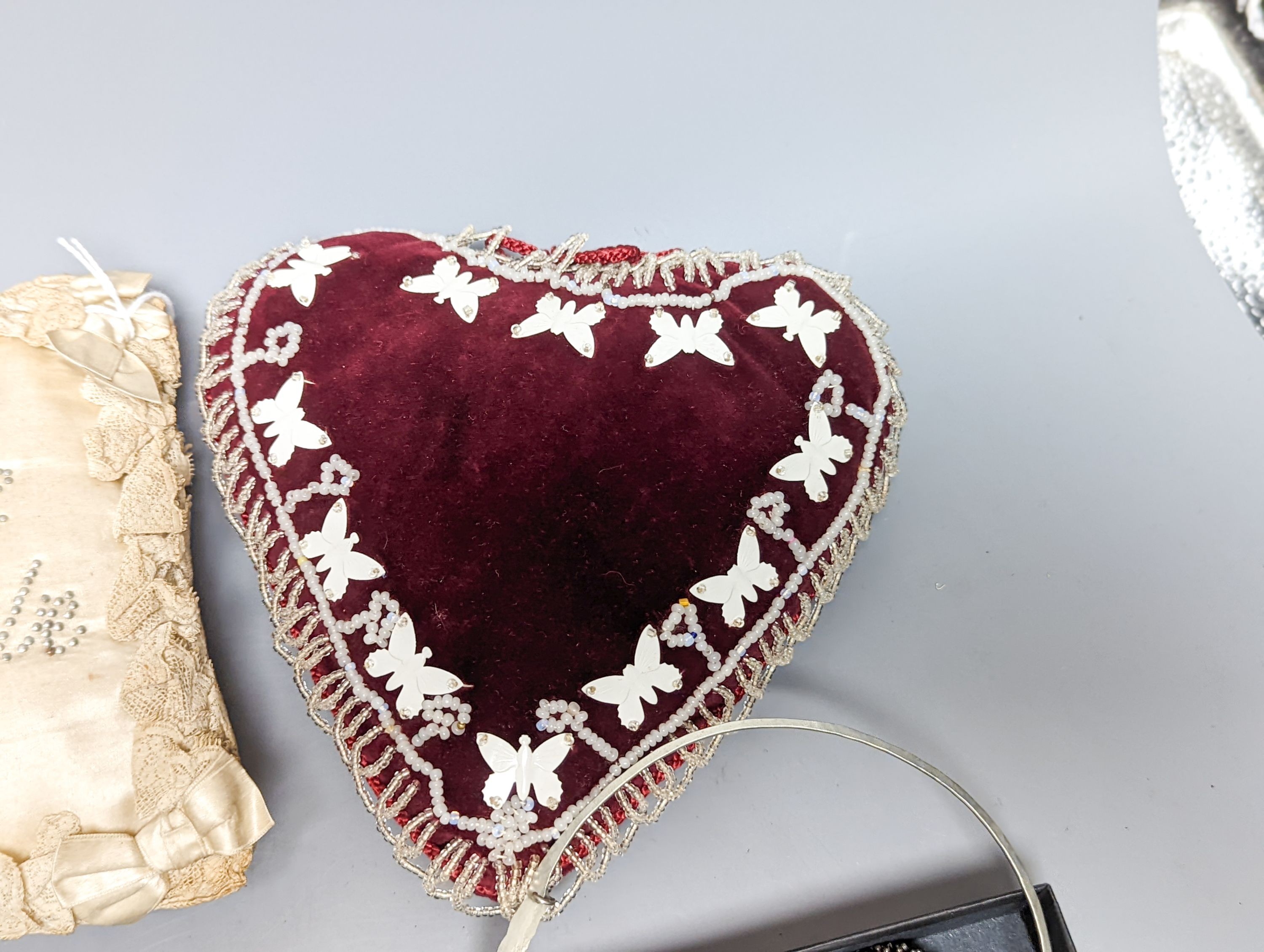 A cream silk pin baby cushion, a valentine cushion, a miser's purse, appliques and sequin collar